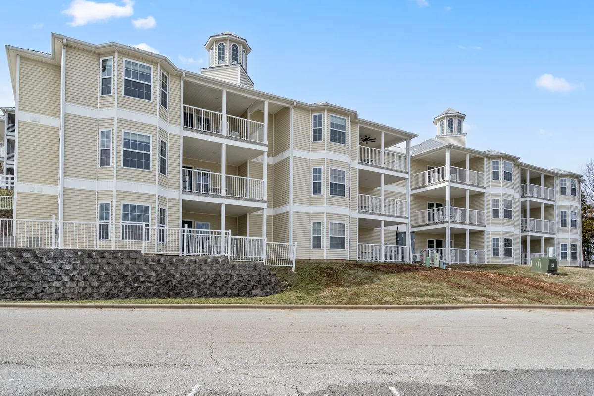 A row of balconies overlooks a scenic area, capturing the golden glow of sunset over the landscape. The architectural details and inviting outdoor spaces suggest a welcoming atmosphere for evening gatherings, storytelling, and shared moments after a day on the lake.
